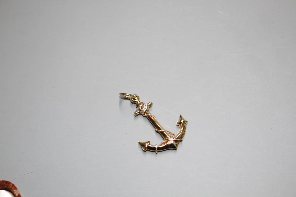 A yellow metal pendant, modelled as an anchor,